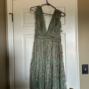 Beautiful low cut dress back and front with a slit